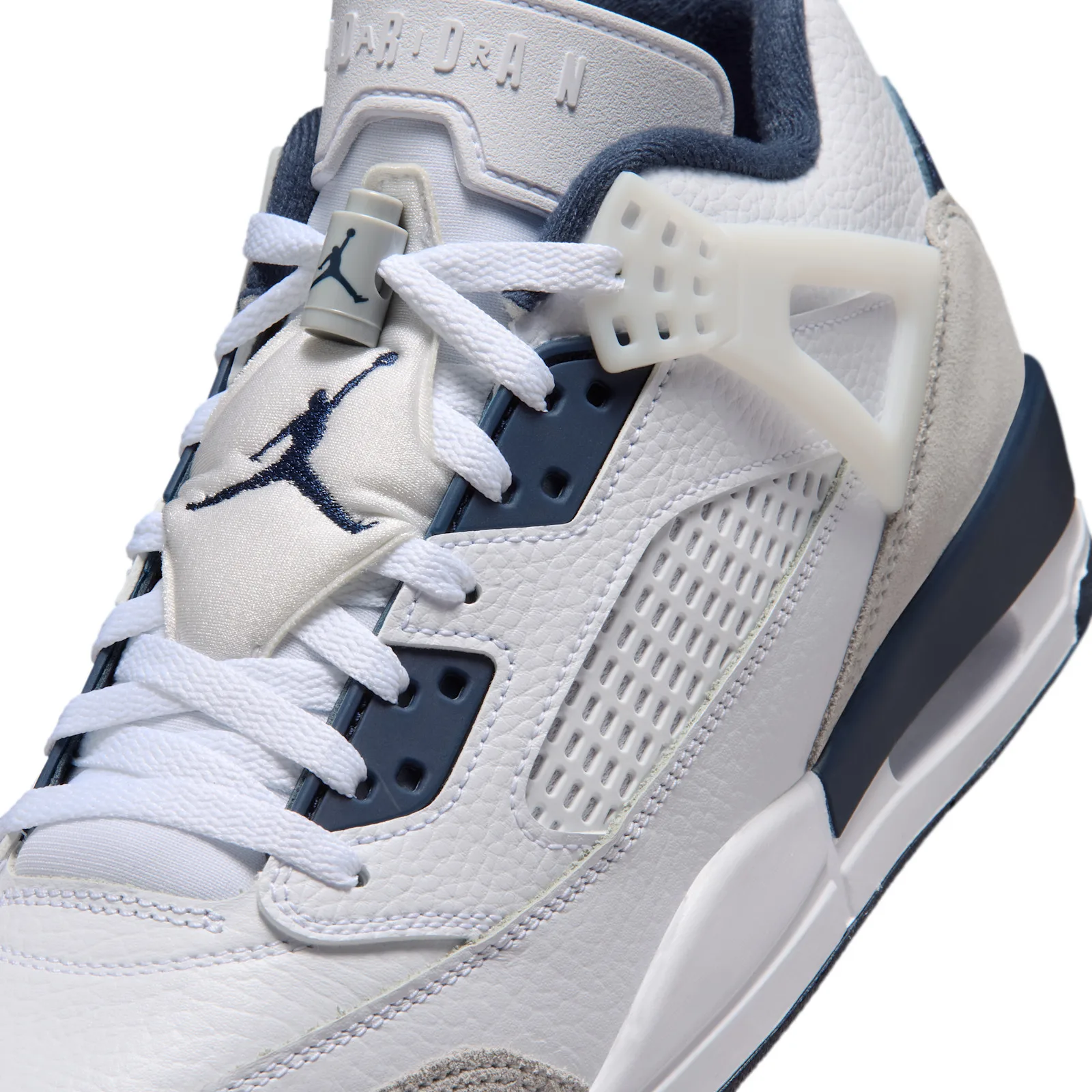 close-up of tongue and eyelets, navy Jumpman logo on white suede with lace lock, Grey Fog