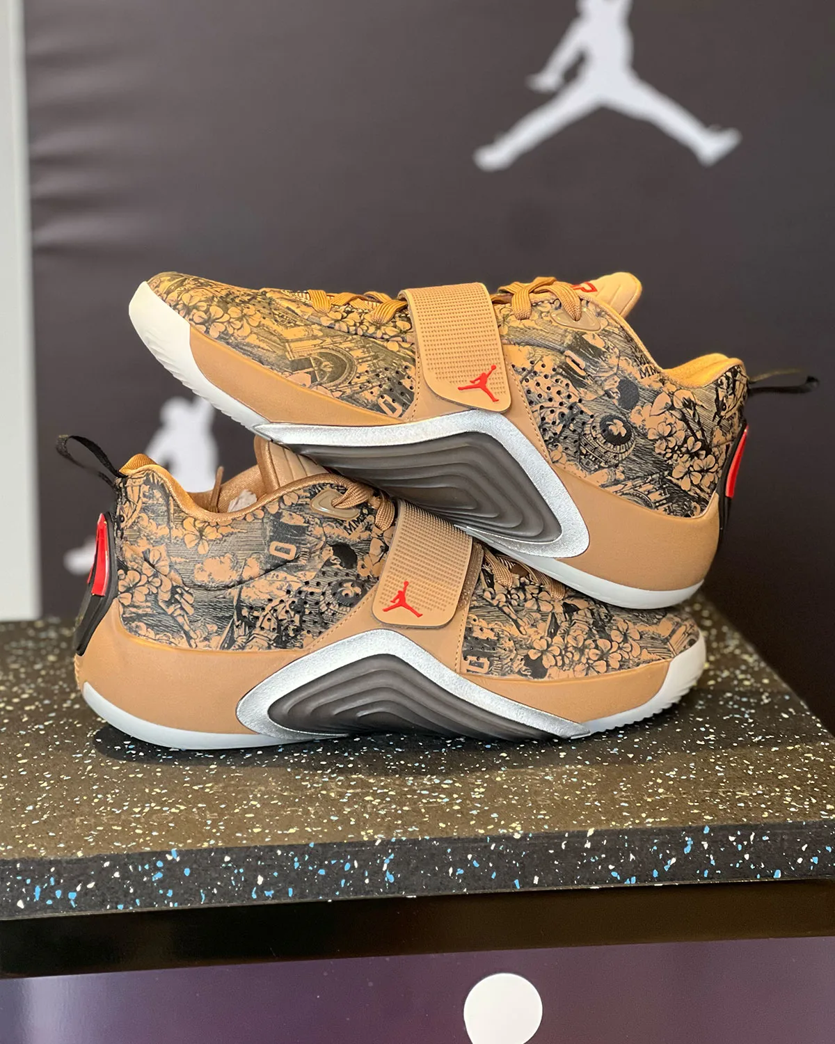 Pair on pedestal, tan floral toile print with red Jumpman logo, Jordan Tatum 5