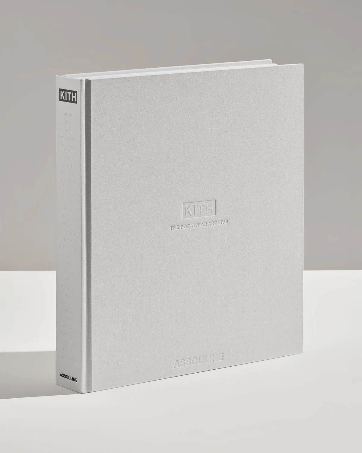 single grey hardcover book, front cover embossed kith footwear archive, The Footwear Archive