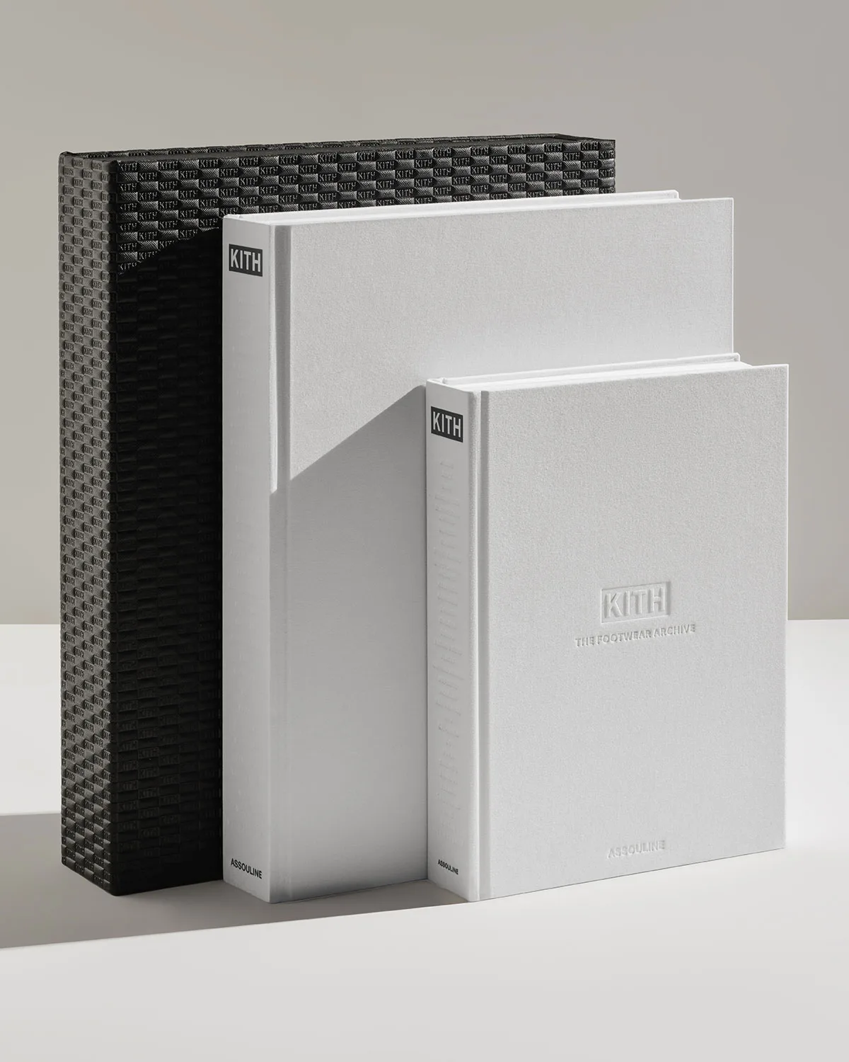 three books, black textured slipcase beside two grey hardcovers, The Footwear Archive