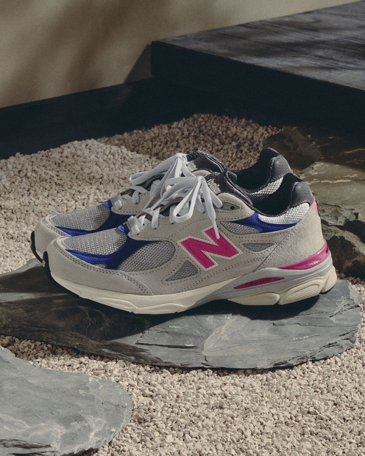 Lateral view, grey suede with pink N logo and blue heel and toe overlays, New Balance 990v3