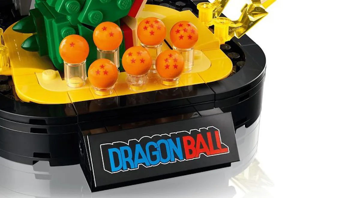 close-up of orange dragon balls and yellow lightning pieces on black base, Shenron & Goku
