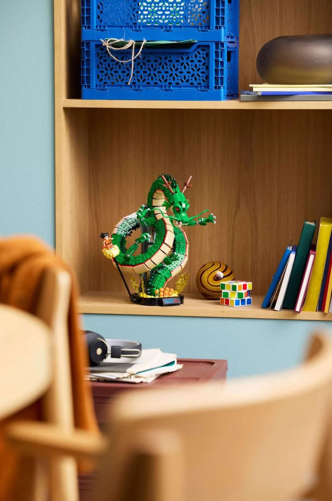 dragon build displayed on wooden bookshelf beside books and rubik's cube, Shenron & Goku