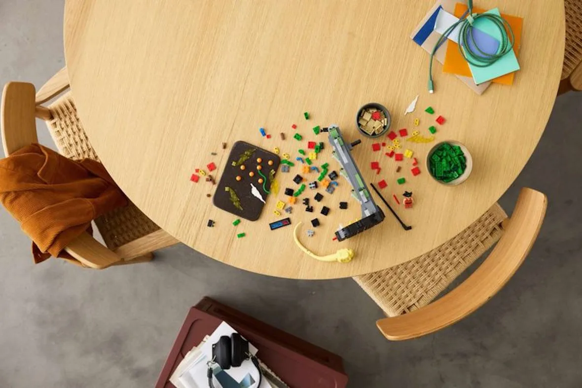top-down view of loose green and yellow LEGO pieces scattered on table, Shenron & Goku