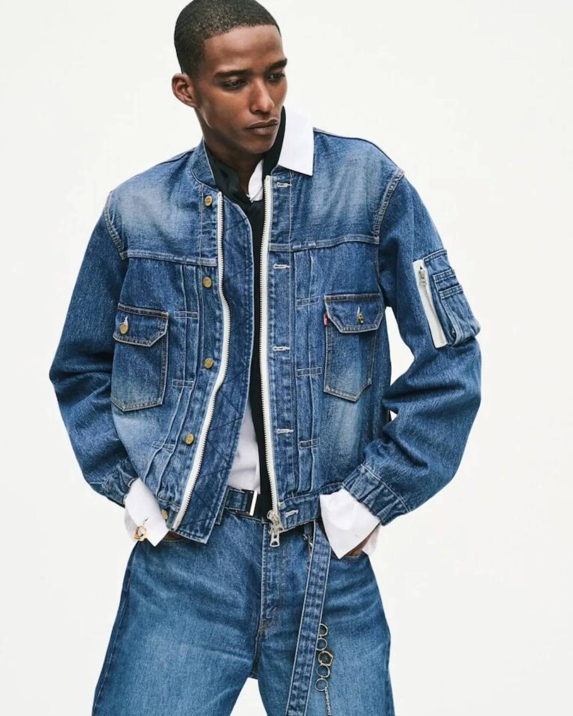 on-model, denim jacket over white collar, jeans with keyring chain detail, Sacai FW26 Collection