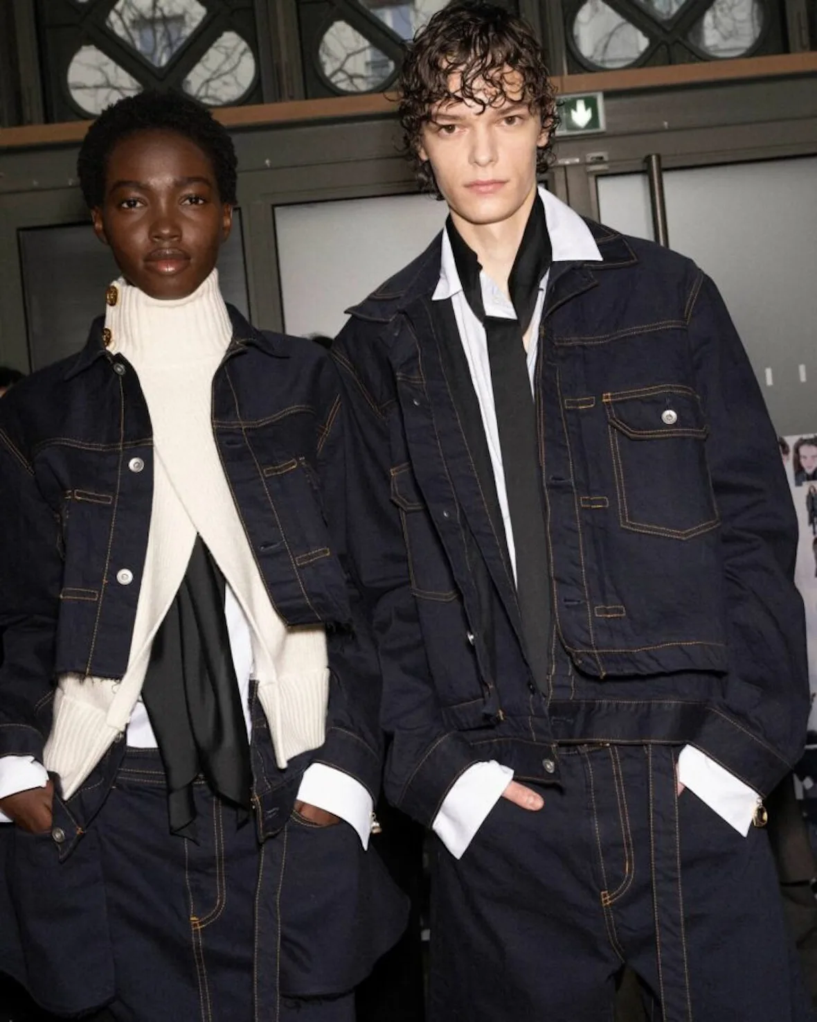 runway pair, dark navy jackets with orange stitching, one over cream knit, Sacai FW26 Collection