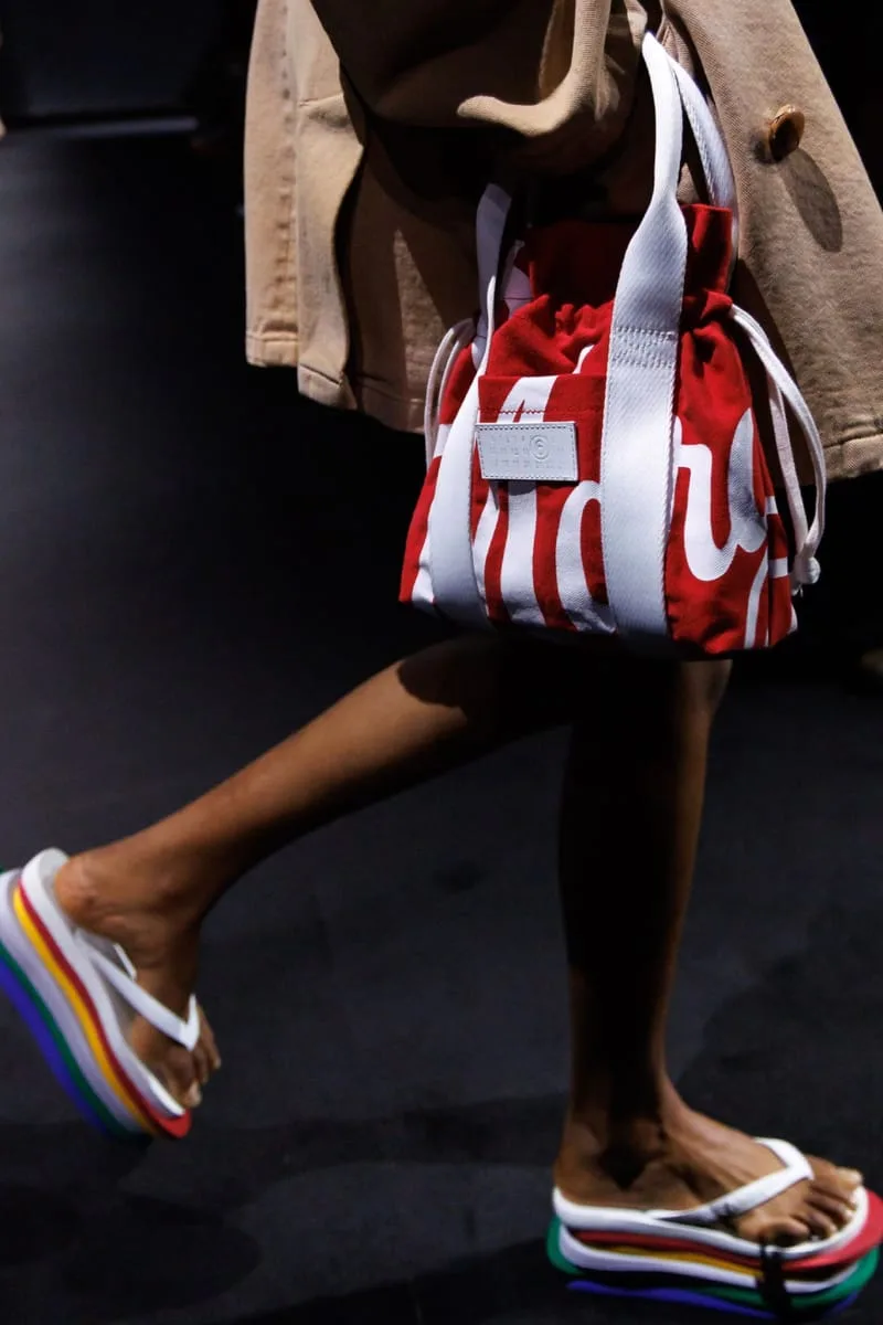 close-up on-foot rainbow platform sole beside red and white logo bag, Havaianas Slim 6Toe