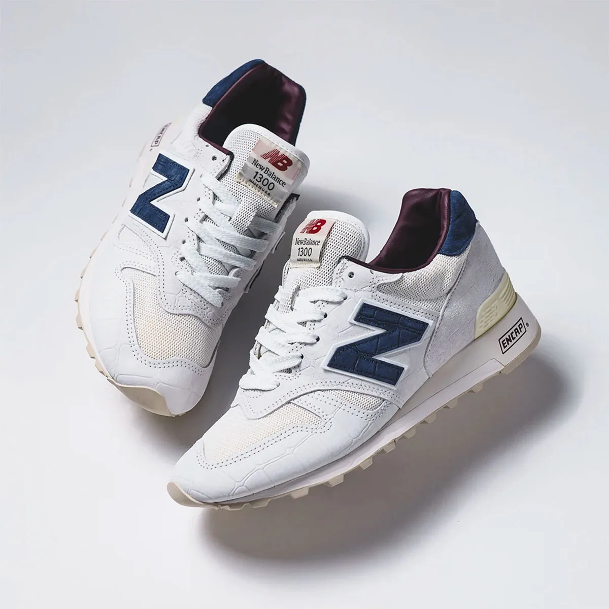 pair, top-down angle showing navy N logos, burgundy tongue lining and New Balance 1300 tag, Sea Salt