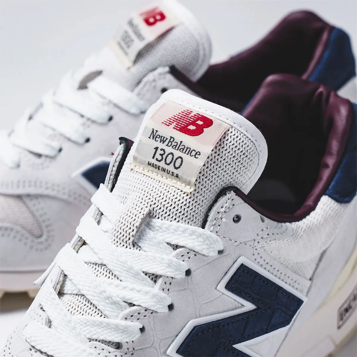 close-up tongue tag reading New Balance 1300 Made in U.S.A. with burgundy lining, Sea Salt