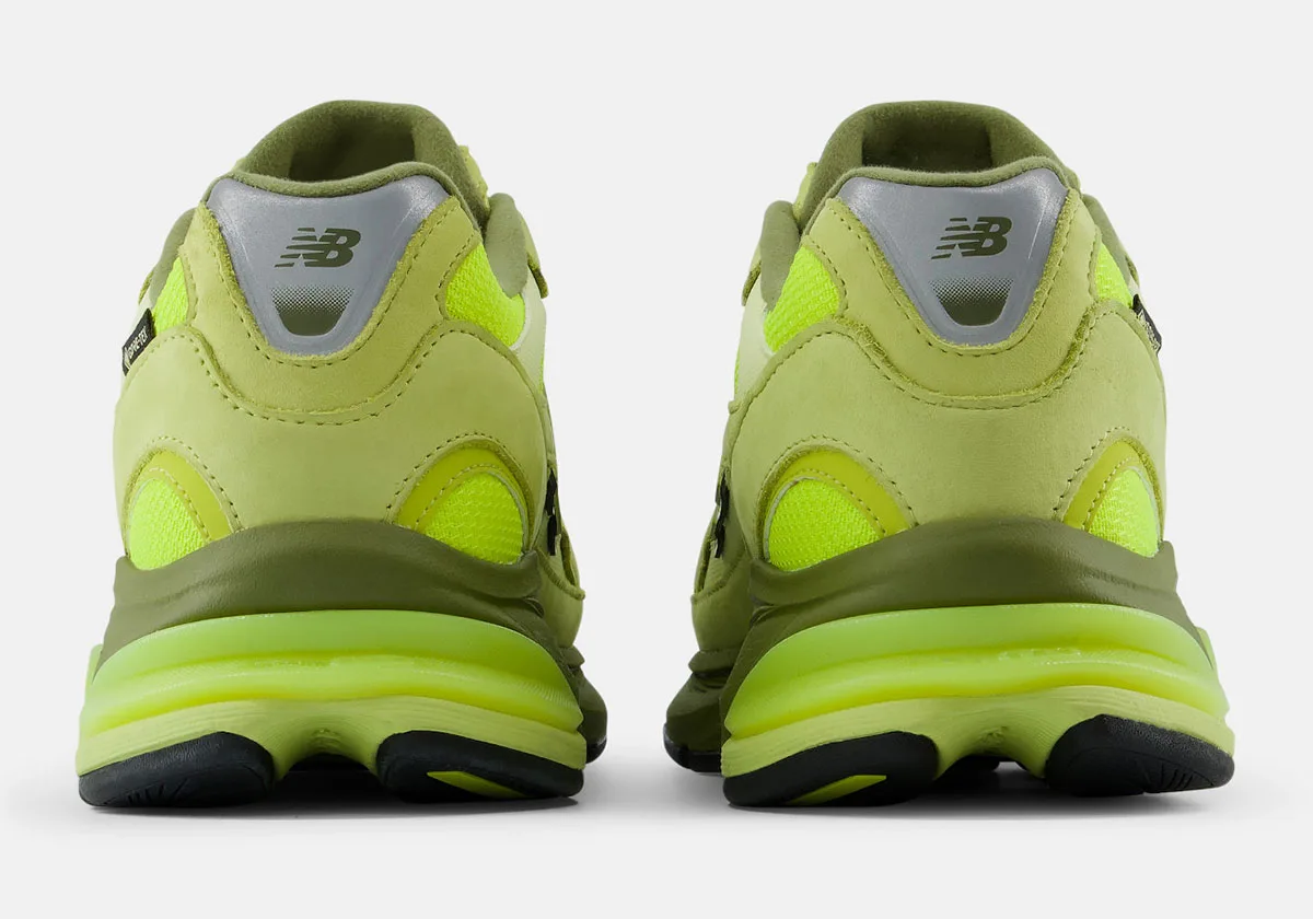 heel view of pair, silver New Balance panel above olive midsole, Neon Green