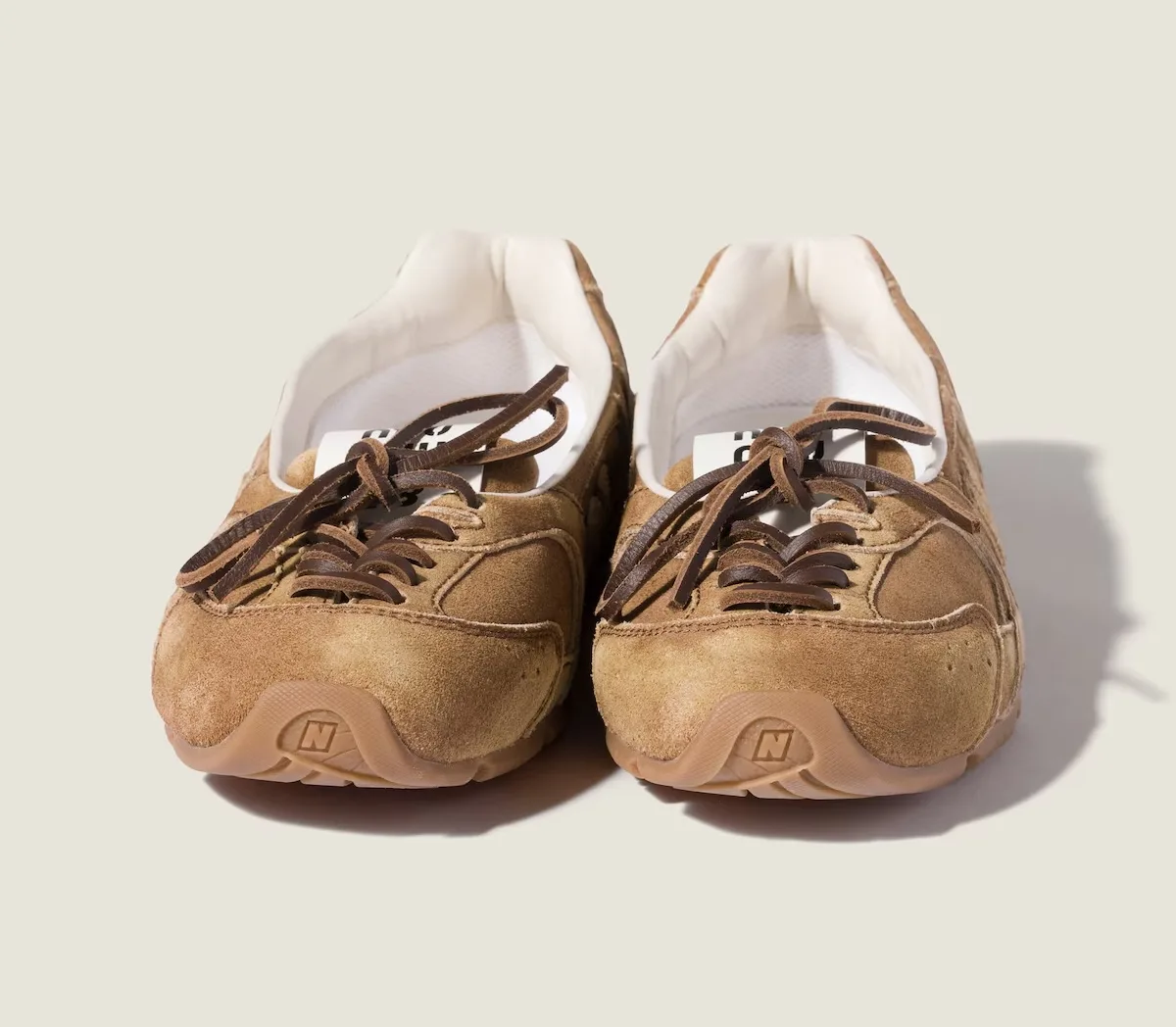 toe-on pair, tan suede with brown crisscross laces and N logo on sole, SL Ballerina Pack