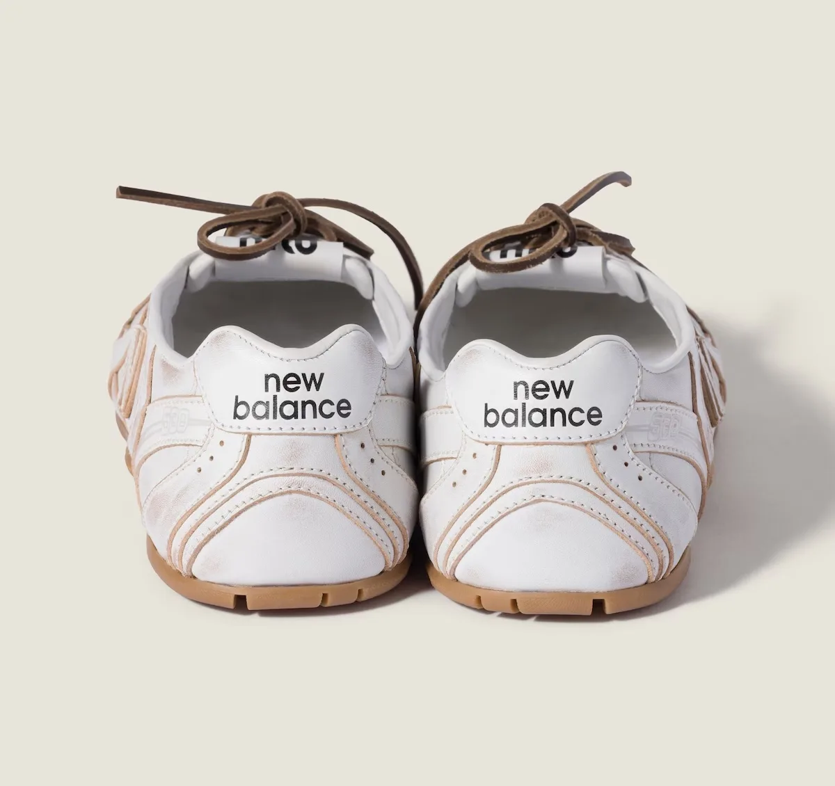 heel view pair, white leather with new balance wordmark and tan piping, SL Ballerina Pack