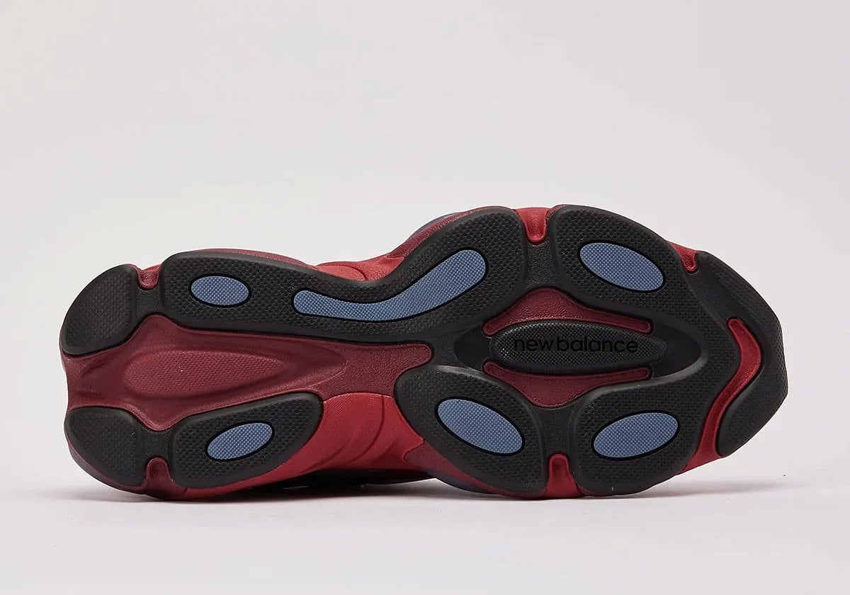outsole view with black lugs, blue accents and new balance text in tread, Red Patent