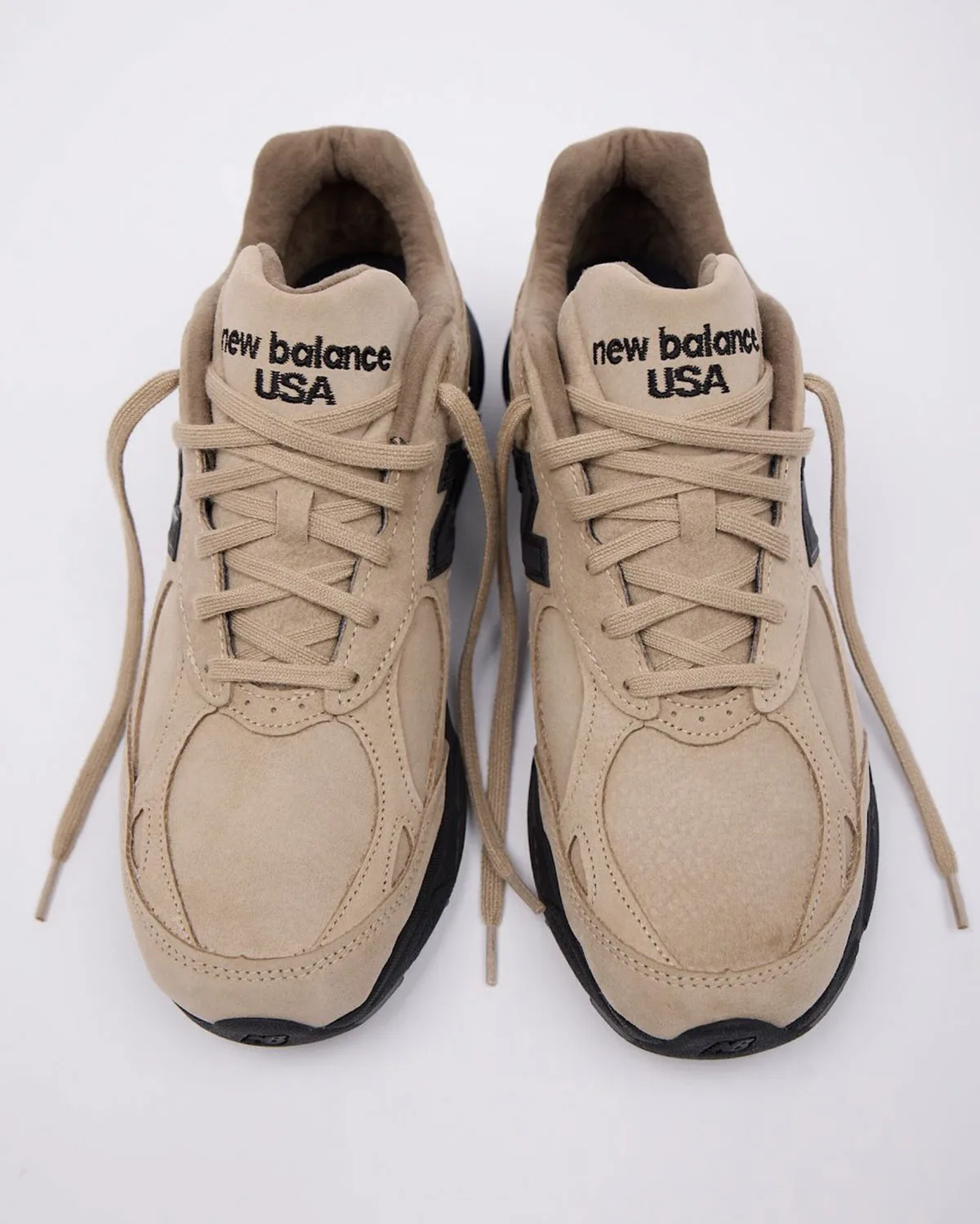 top-down pair view with tan suede uppers and black soles, laces crossed, Tan Suede