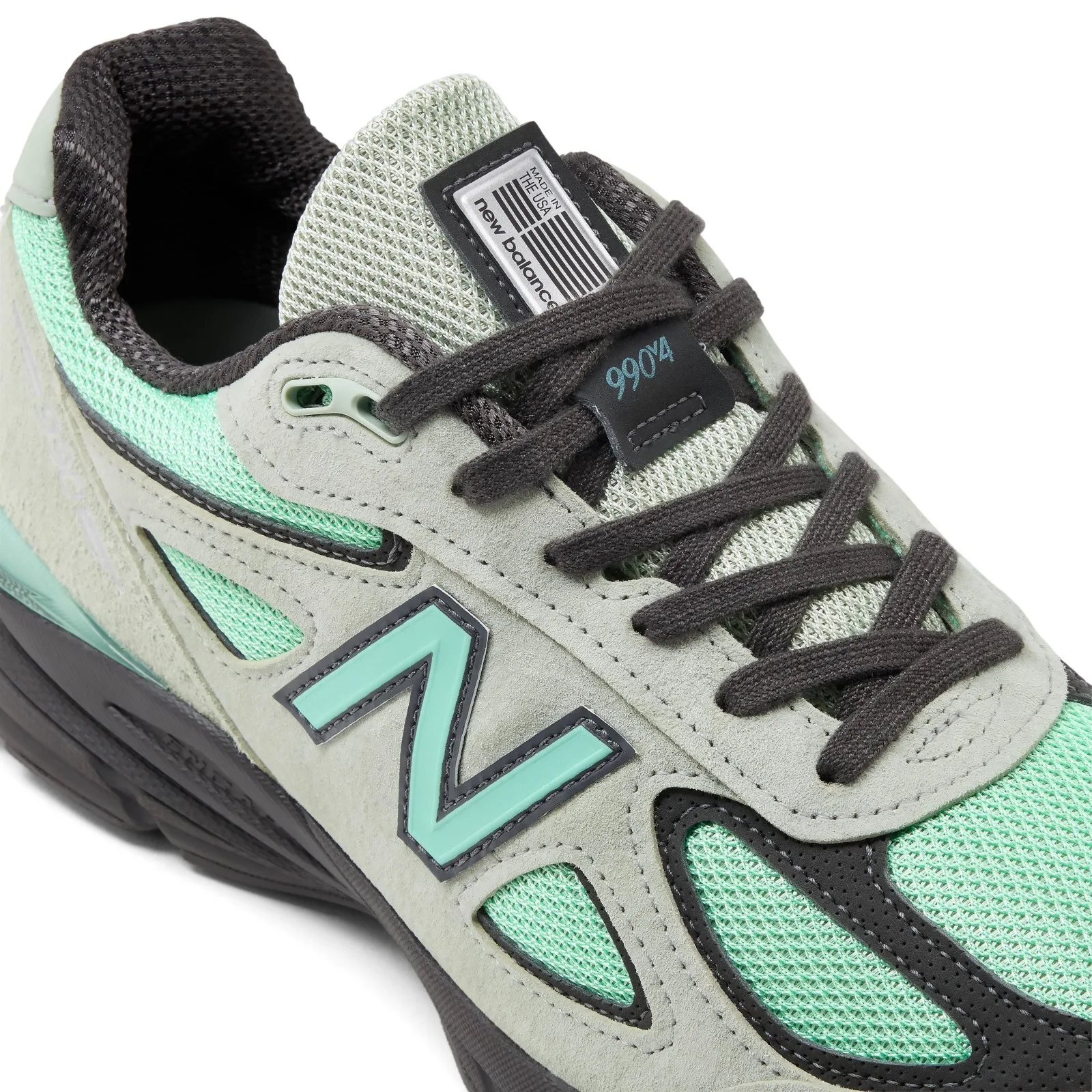 close-up of laces crossing tongue, silver made in usa tag, teal N logo, Silver Moss/Bright Mint