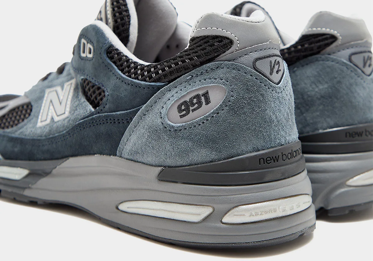 heel and back detail, 991 and V2 tags on slate blue suede with new balance branding, Elevated Essentials