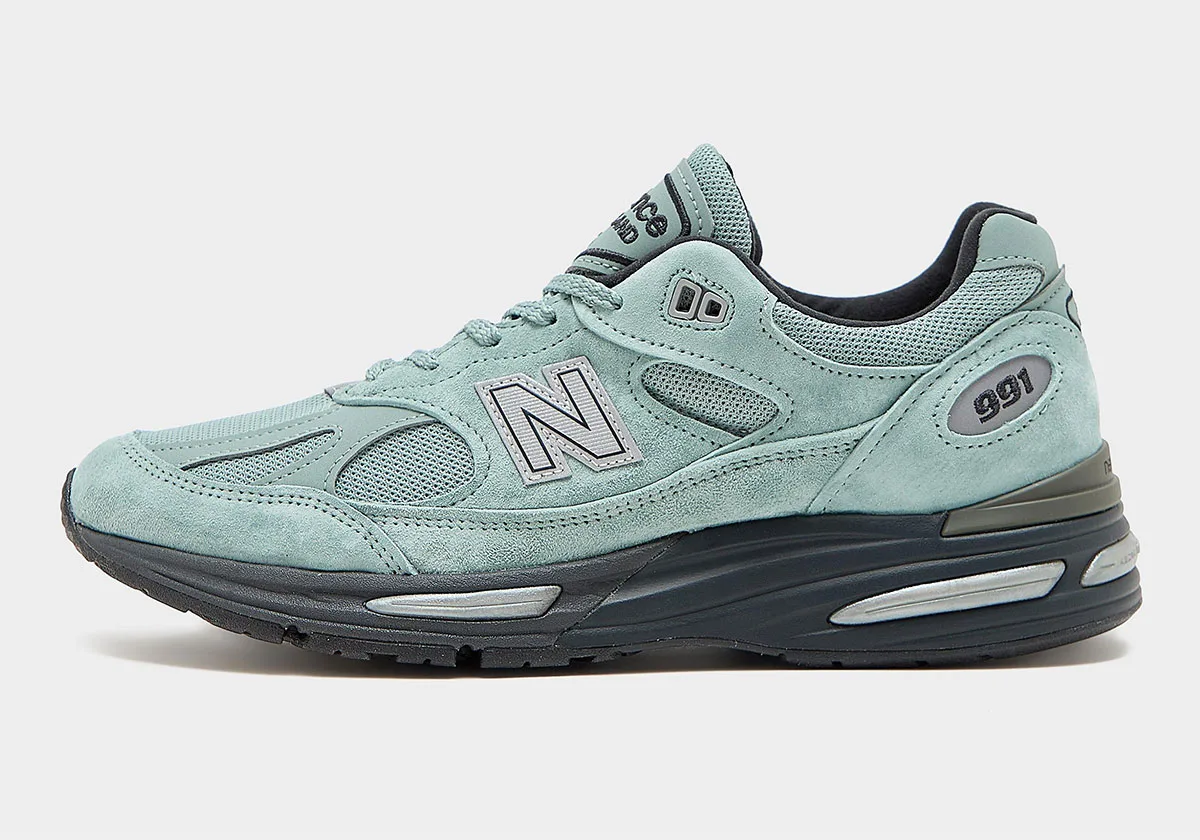 lateral side view in sage green suede with grey N logo and dark grey midsole, New Balance 991v2 “Green Milieu”