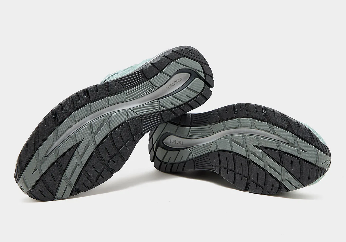 outsole view of both shoes showing black and grey FuelCell tread pattern, Green Milieu