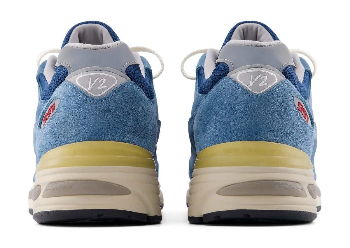 heel pair view with red 991 text and grey V2 tab on blue suede, Poseidon