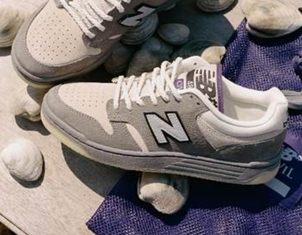 Pair on light stones with purple cloth, grey suede, white N logo and purple accents, New Balance Numeric x Civil 480