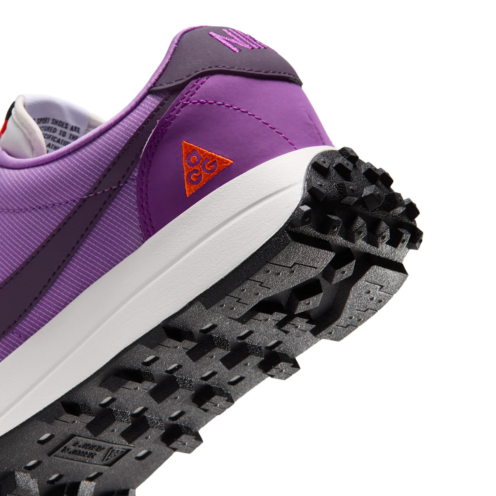 Angled heel-toe detail, orange ACG triangle logo above lugged outsole, Monarch Purple