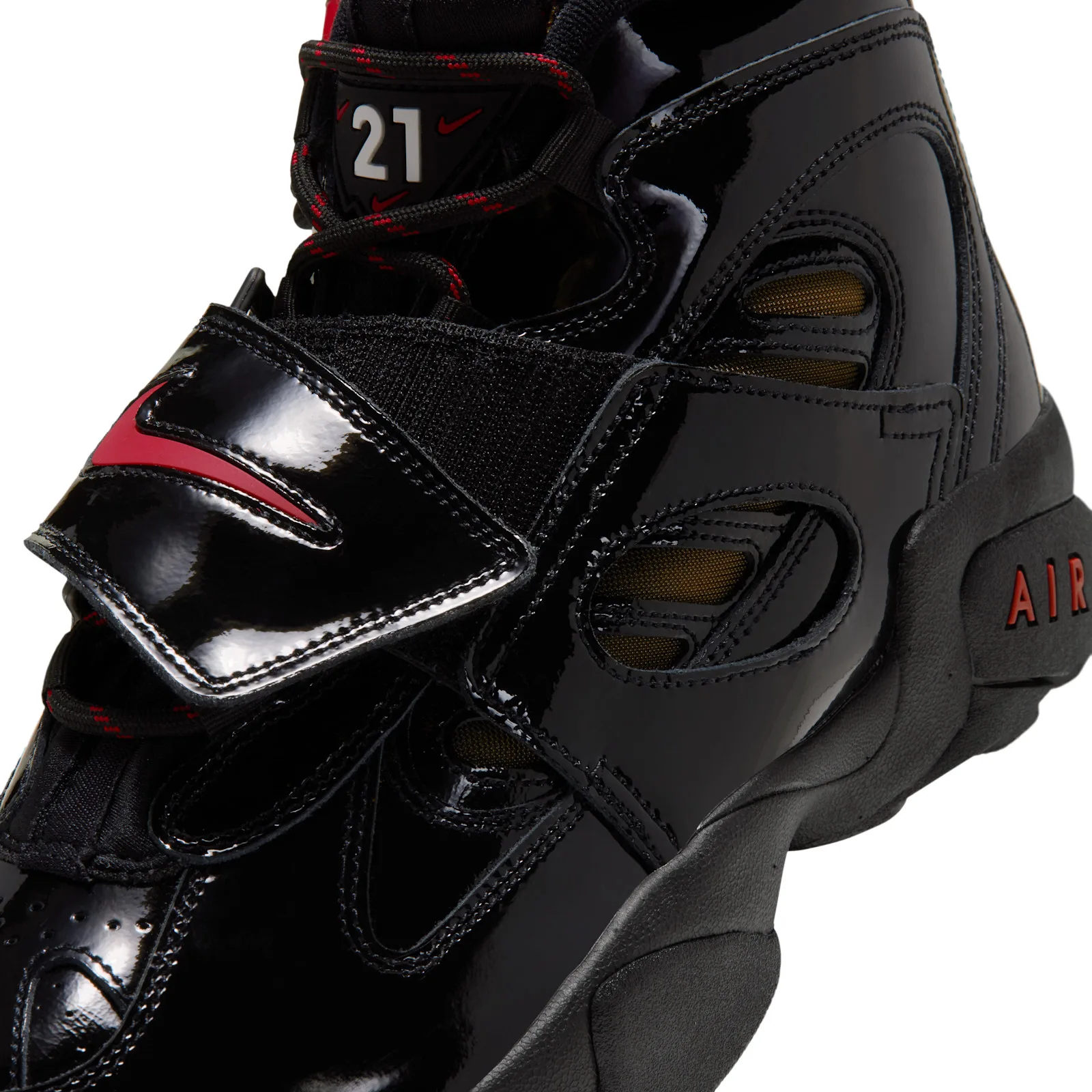 close-up of toe box and strap showing red swoosh, gold mesh vents and red AIR sole text, Black Patent