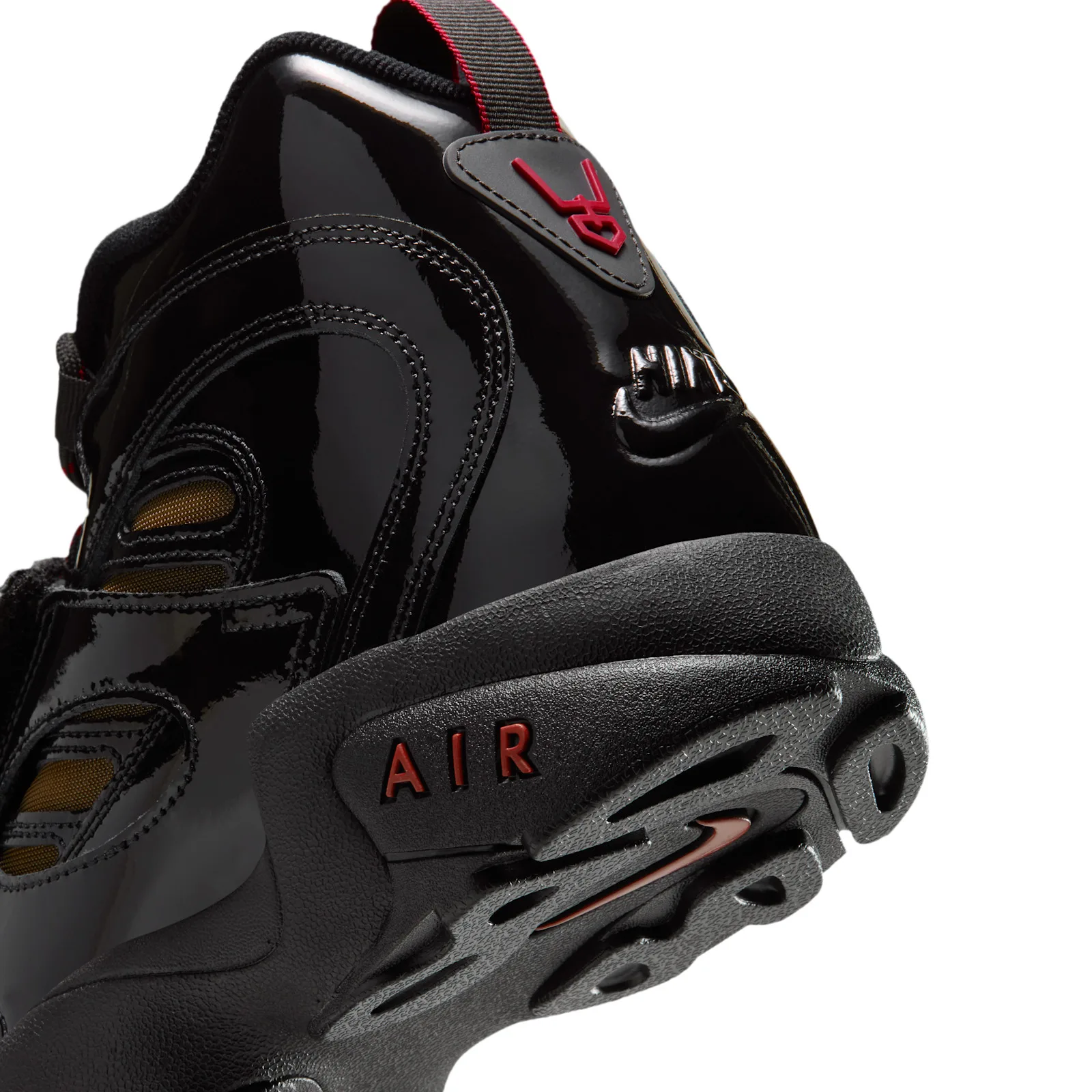 close-up heel detail with red 21 tab, embossed Nike text and red AIR text on sole, Black Patent