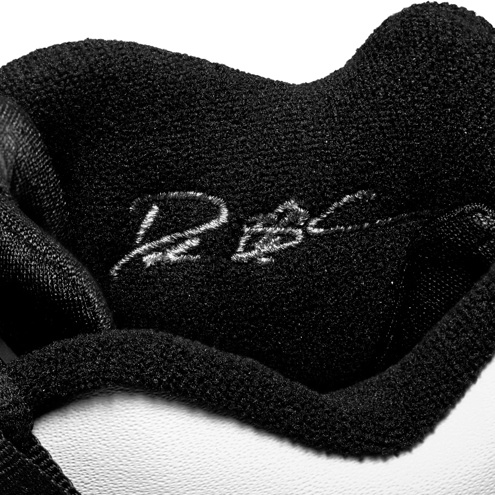 close-up interior heel lining, RBC text embroidered on black fabric, White/Black
