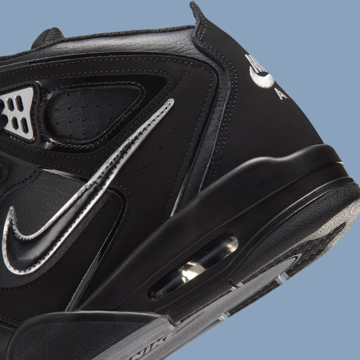 close-up detail, black upper with silver swoosh outline and mesh vent panel, Air Flight Falcon