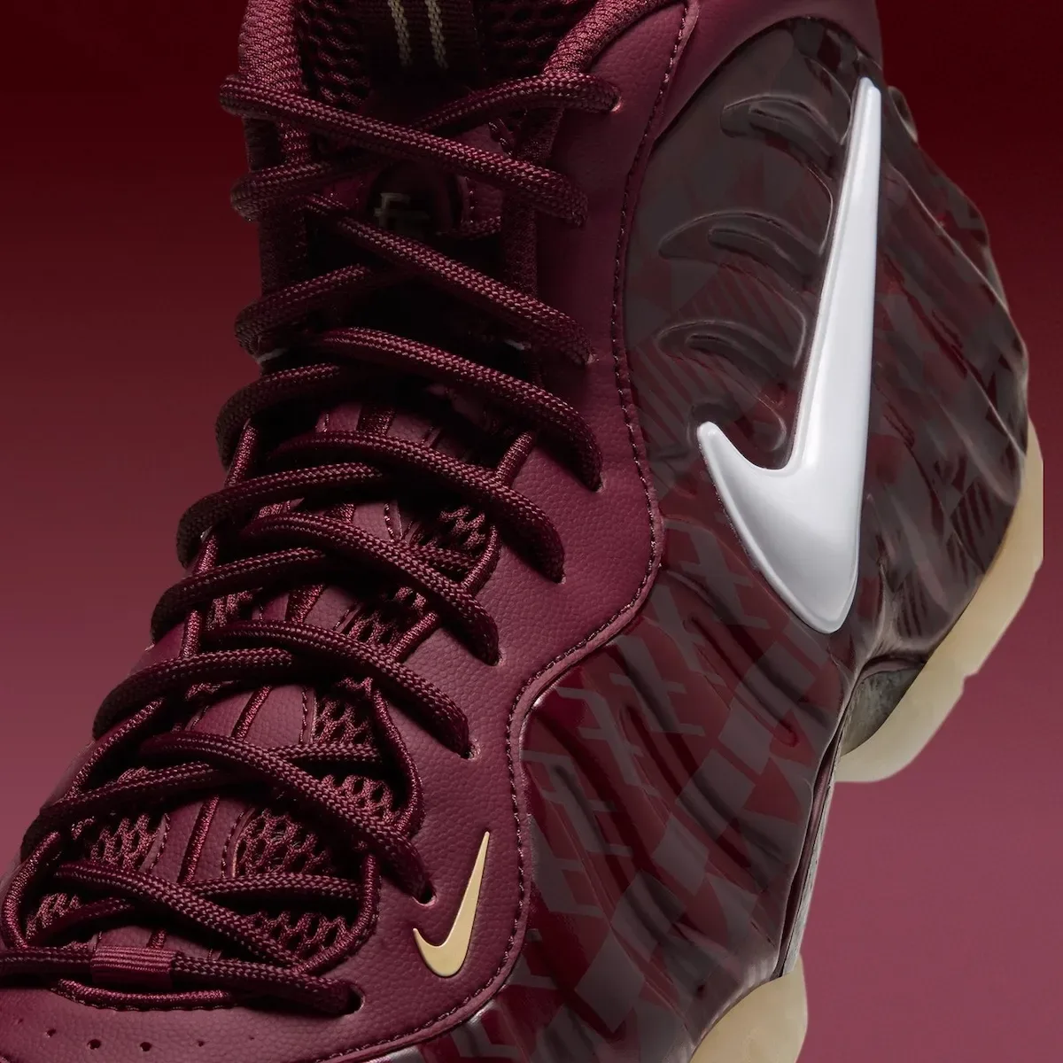 close-up toe and lateral view highlighting glossy white swoosh on maroon, FSU