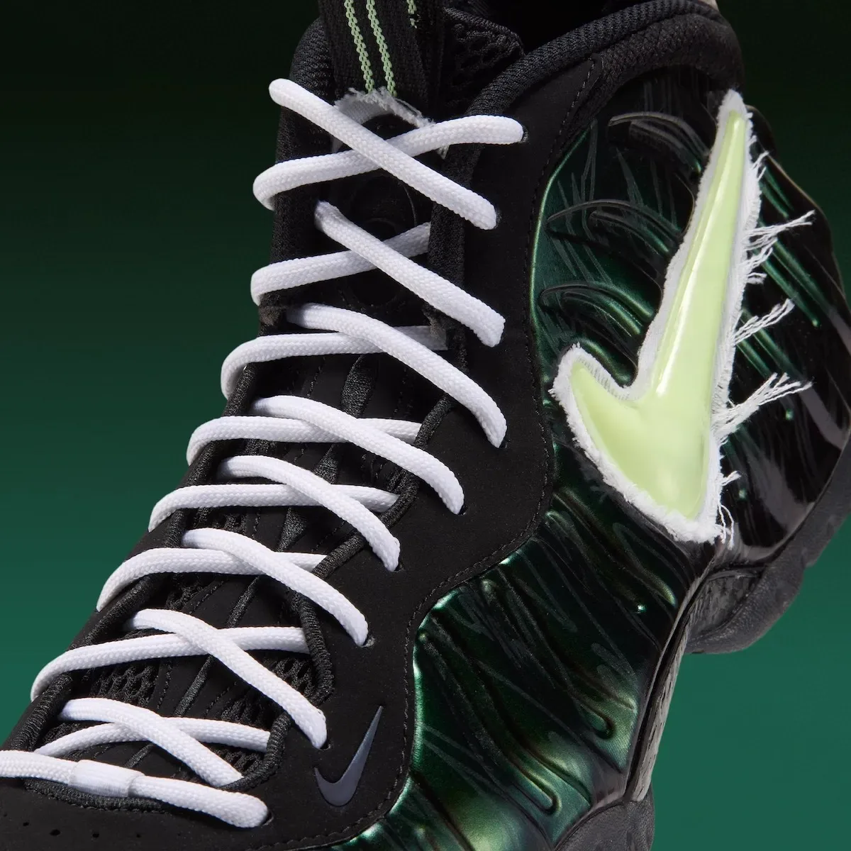close-up front view of frayed pale-green swoosh and white crossed laces, Mummy Duck