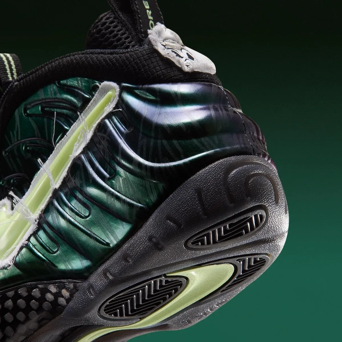close-up heel and outsole, textured black tread and green iridescent shell, Mummy Duck