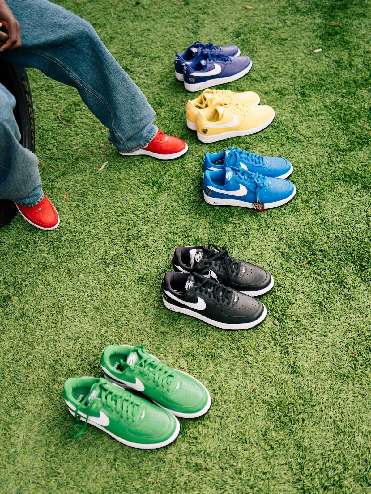 group of pairs on grass in navy, yellow, blue, black and green, red pair worn, Victor Victor Collection