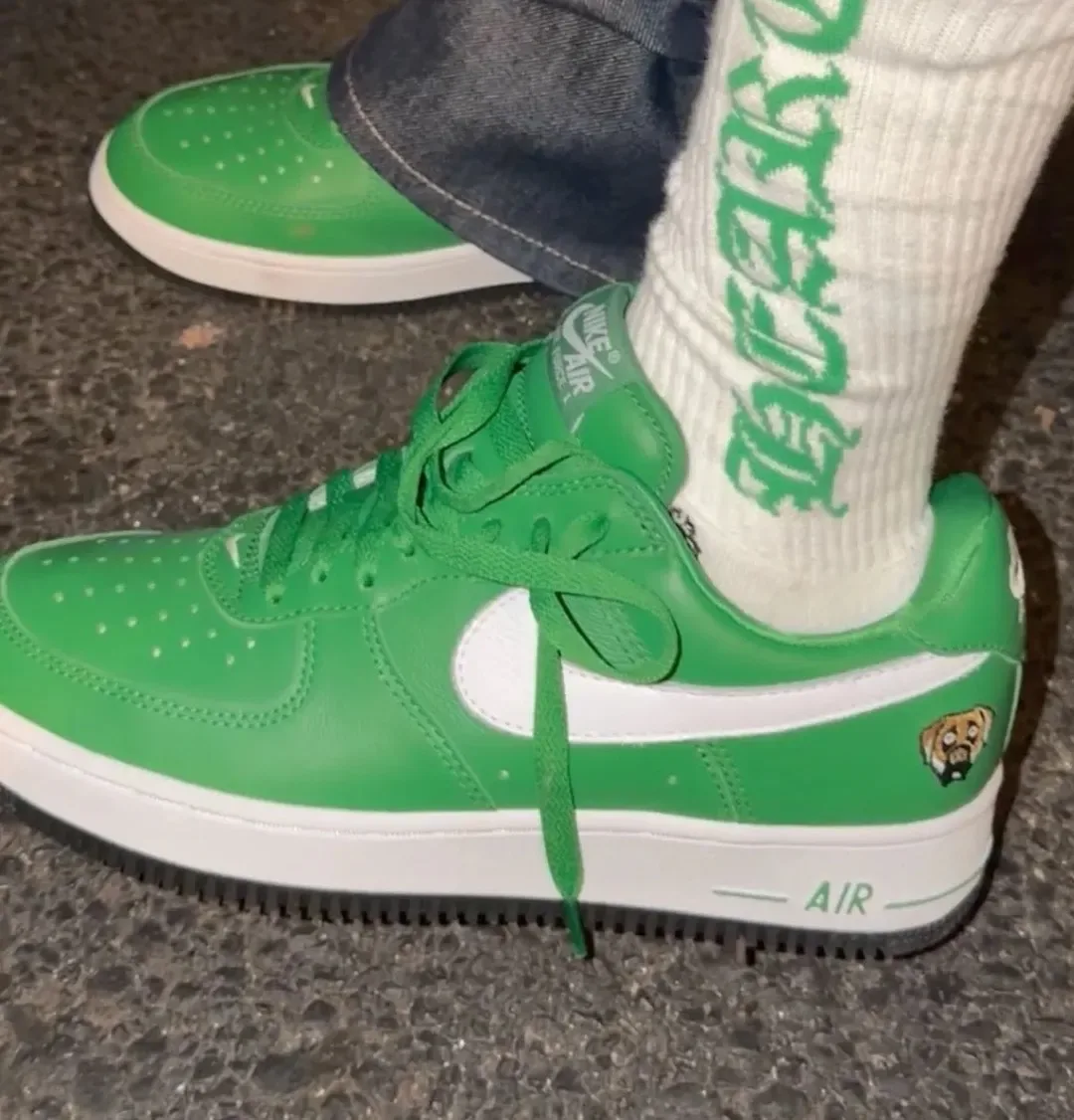 on-foot medial view in green leather with white swoosh and dog patch on heel, Victor Victor Collection