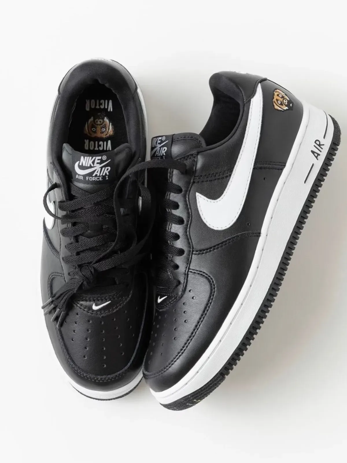 top-down pair in black leather with white swoosh and Victor tongue text, Victor Victor Collection