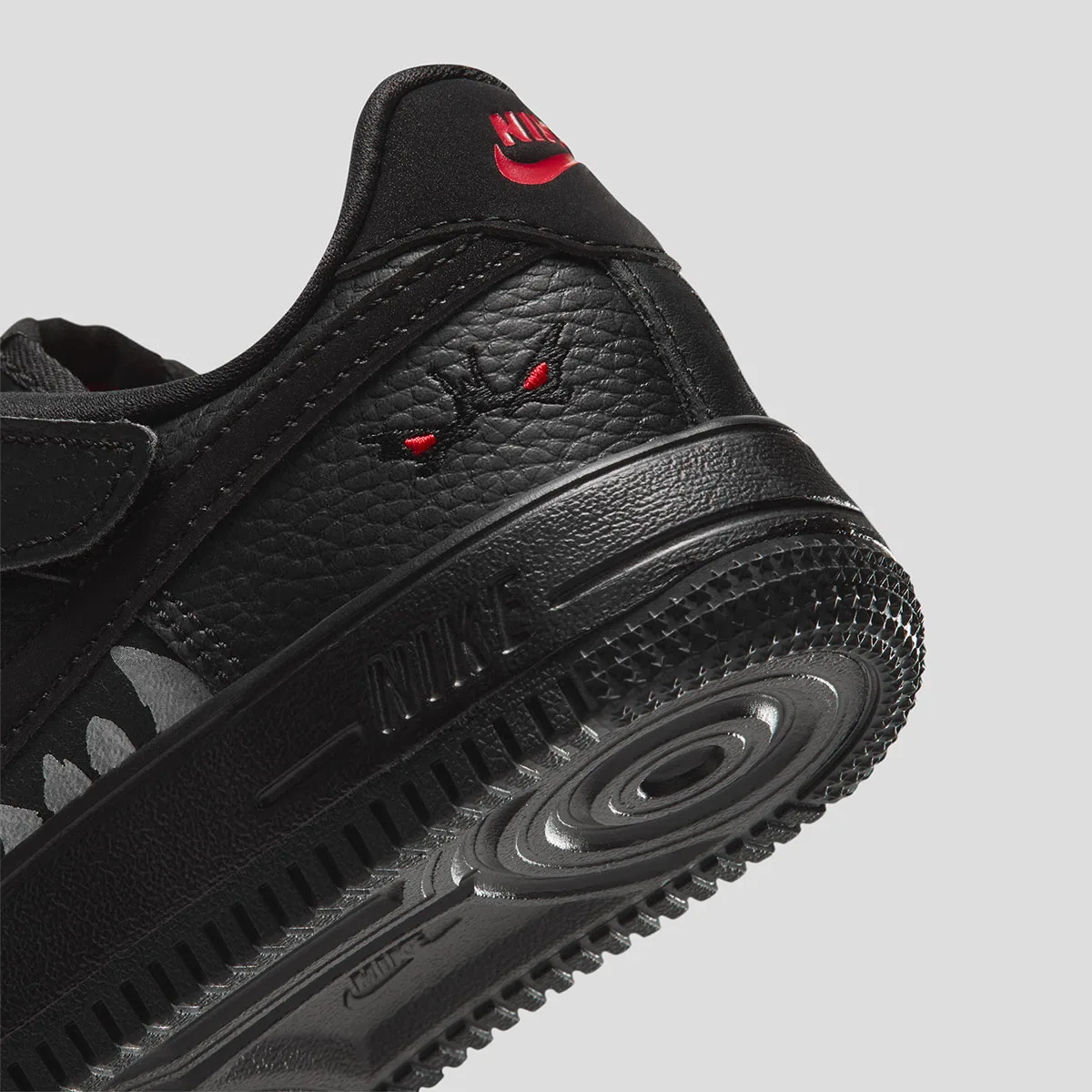 heel close-up, small red-eyed creature embroidery above the outsole tread, Beast