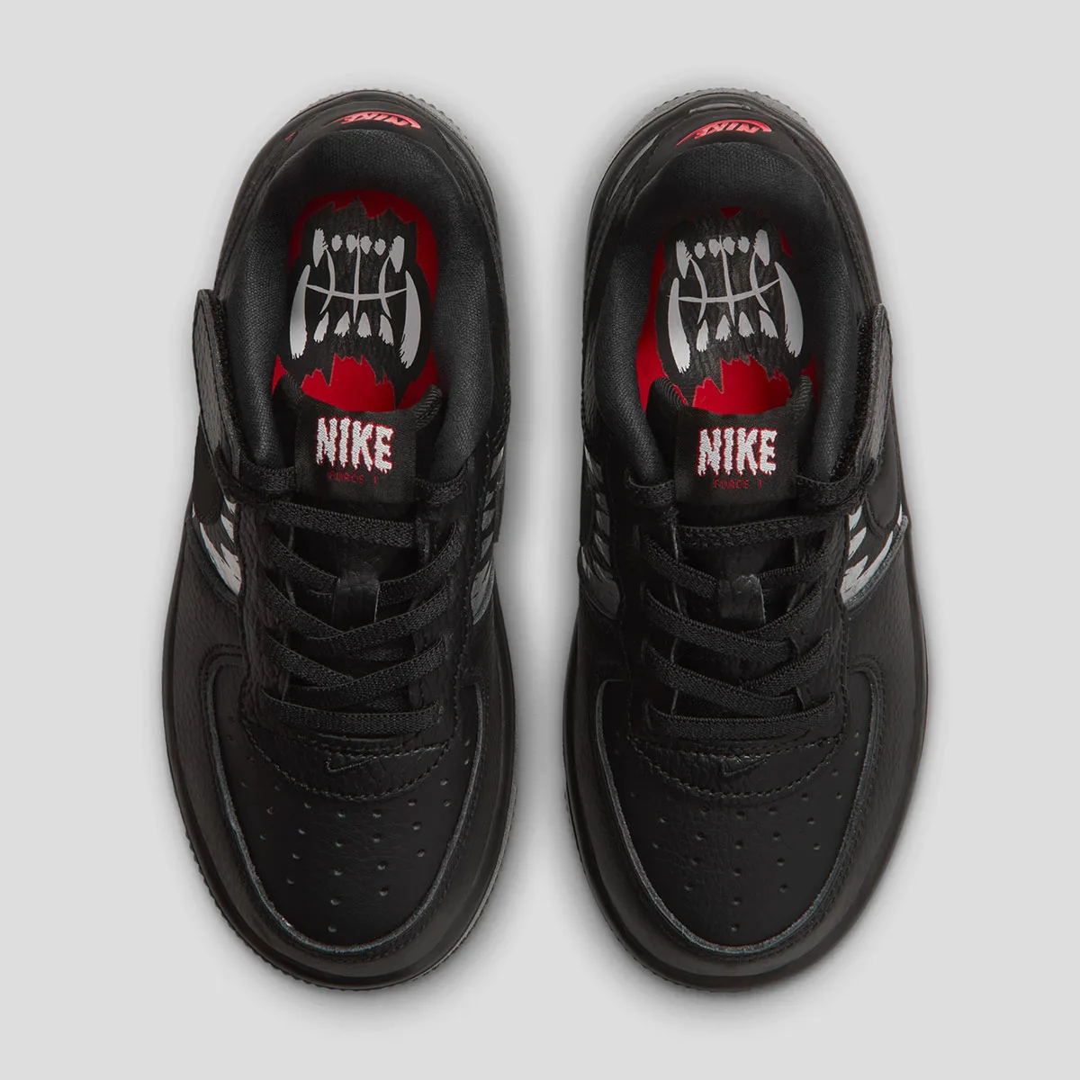 top-down pair, red insole with white fang graphic and red Nike Force 1 tongue text, Beast