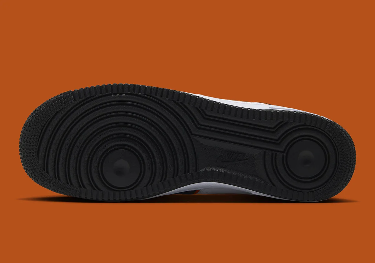 outsole close-up, black tread with white midwall and Nike branding, Campfire Orange