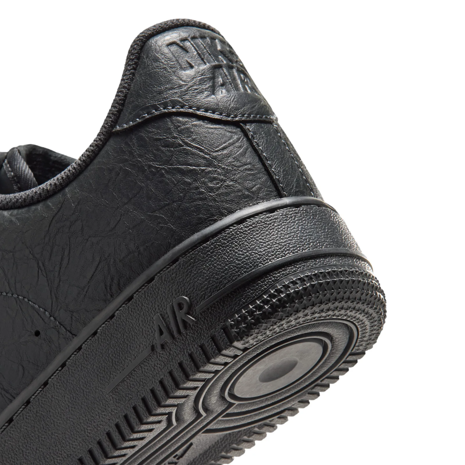close-up heel and outsole detail with embossed Nike Air text and ridged tread, Charms