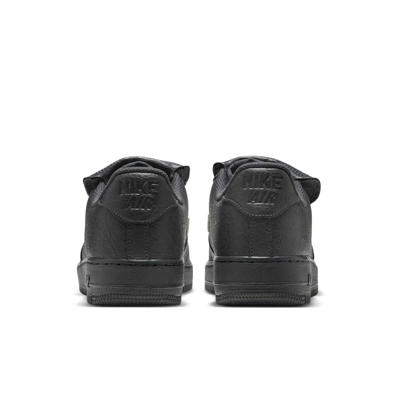 heel view of pair showing embossed Nike Air text on dark grey heel tabs, Charms