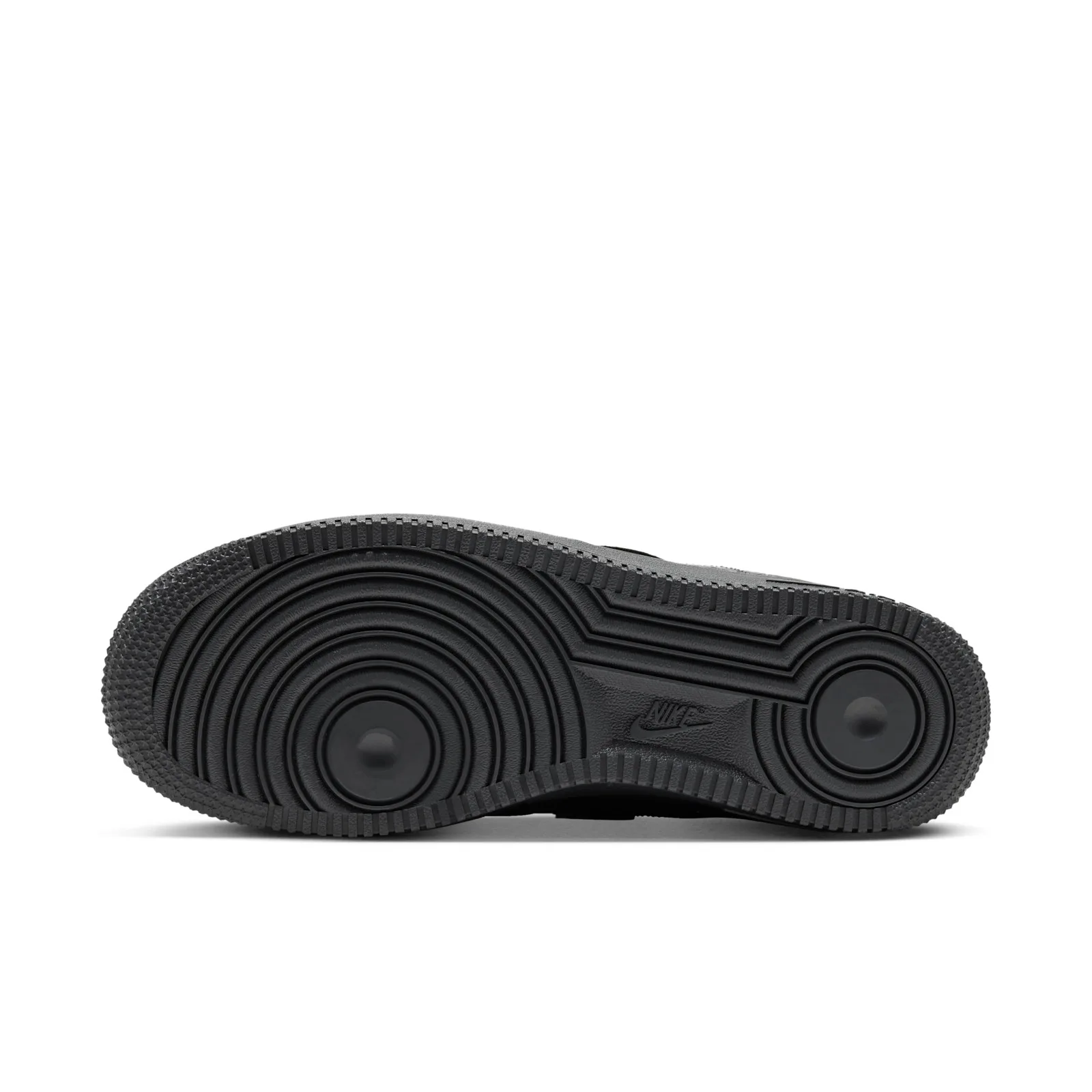 outsole view showing circular tread pattern and embossed Nike branding in grey rubber, Charms