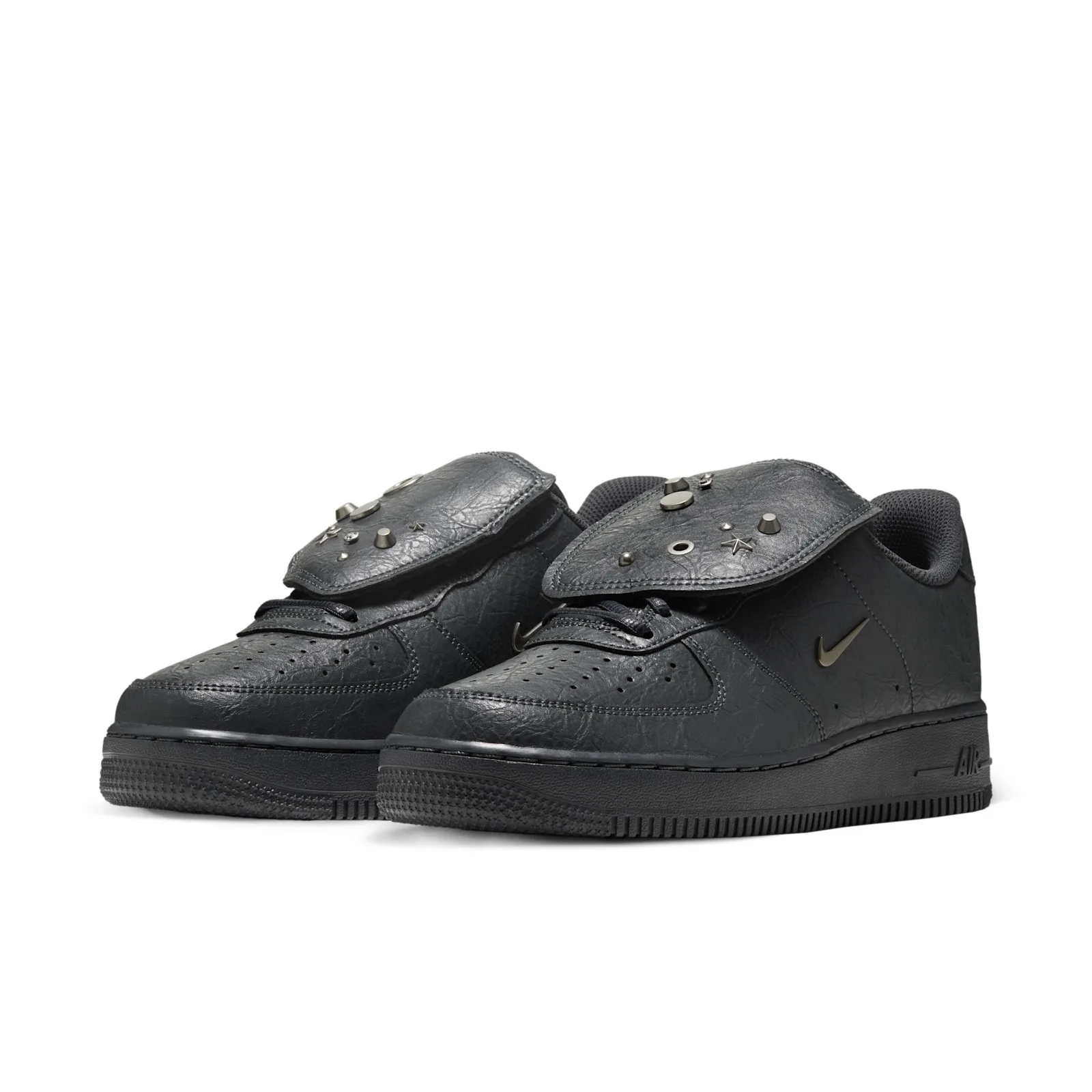 three-quarter pair view, both shoes with metal charms and grommets on raised tongue flaps, Charms