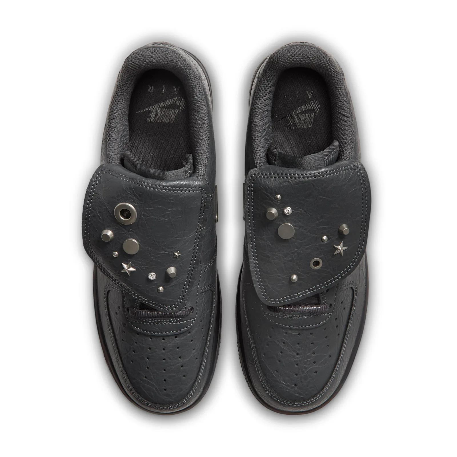top-down view of pair, tongue flaps folded forward revealing charm hardware and studs, Charms
