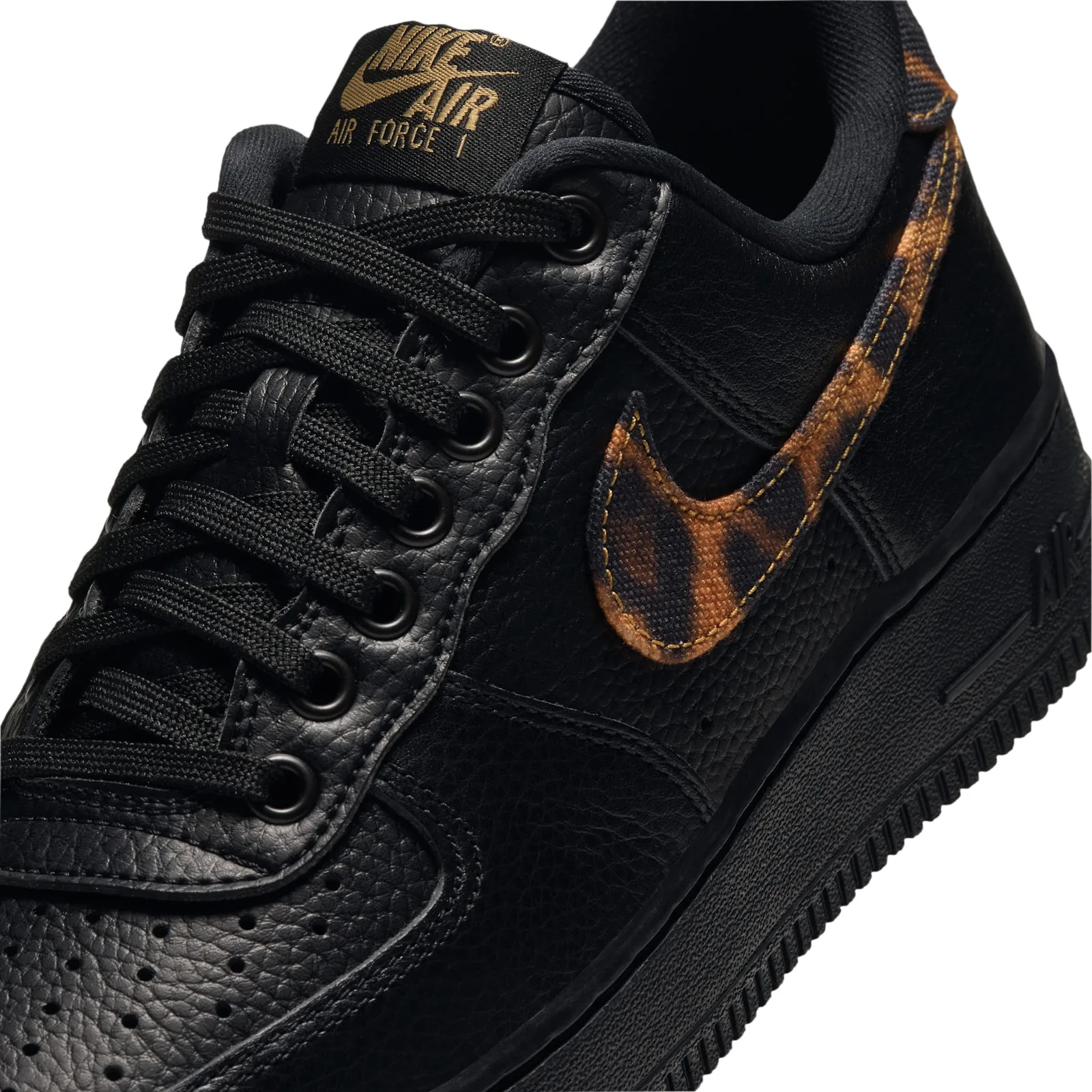 close-up of toe and swoosh showing leopard-print overlay and gold stitching, Leopard