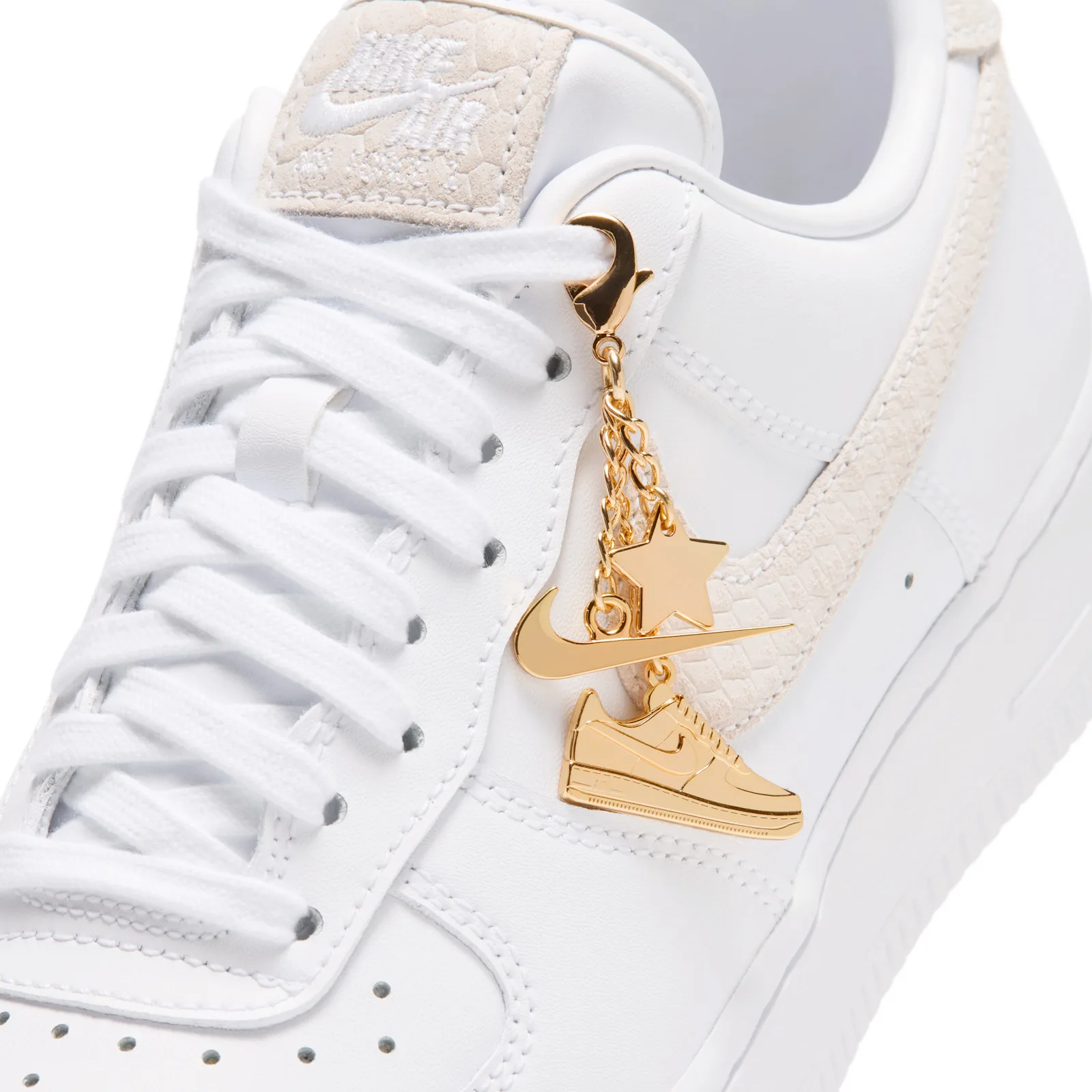 close-up top-down angle, gold star and sneaker charms clipped to laces near swoosh, Metallic Gold Charms