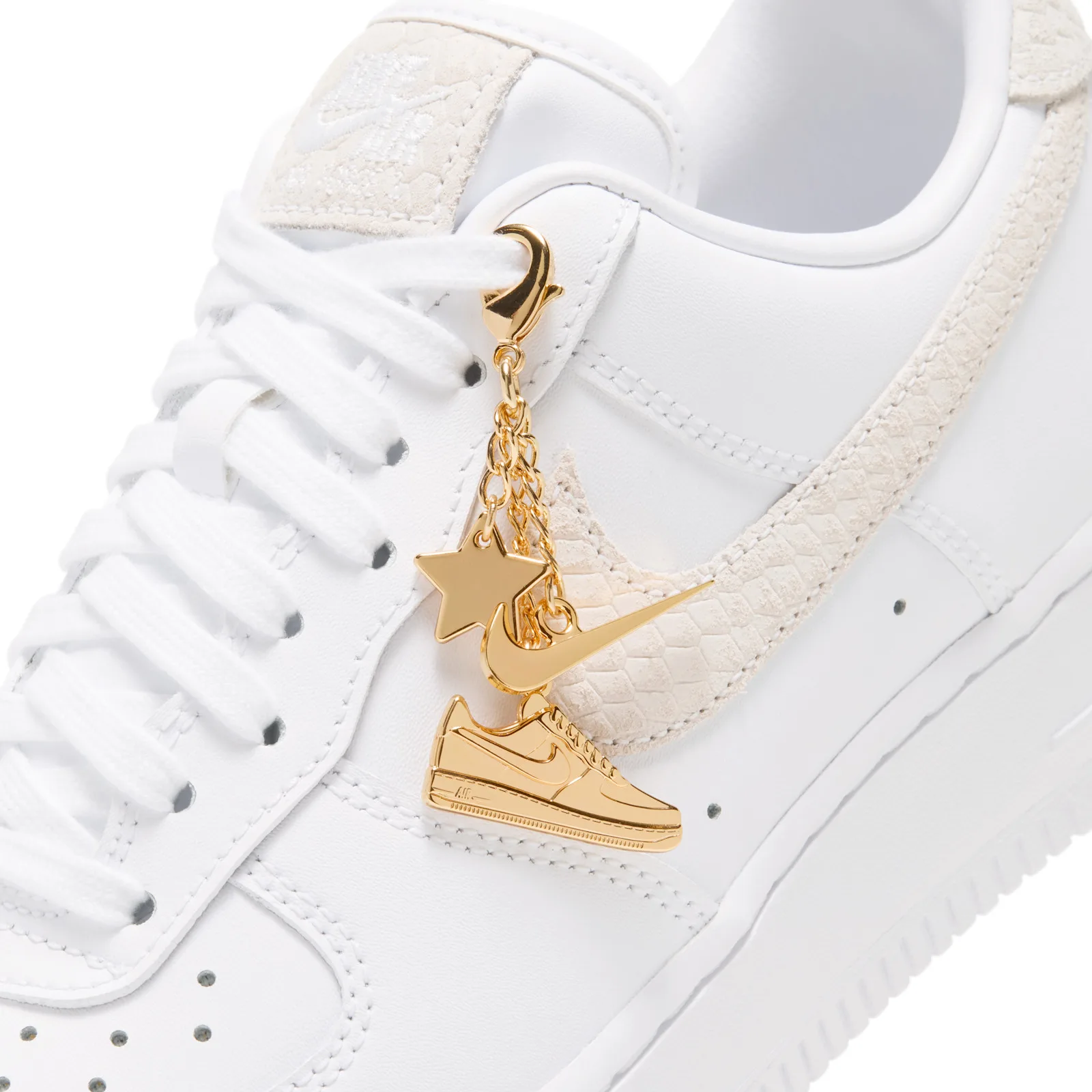 close-up of toe area, gold star and mini gold sneaker charms over cream snakeskin swoosh, Metallic Gold Charms