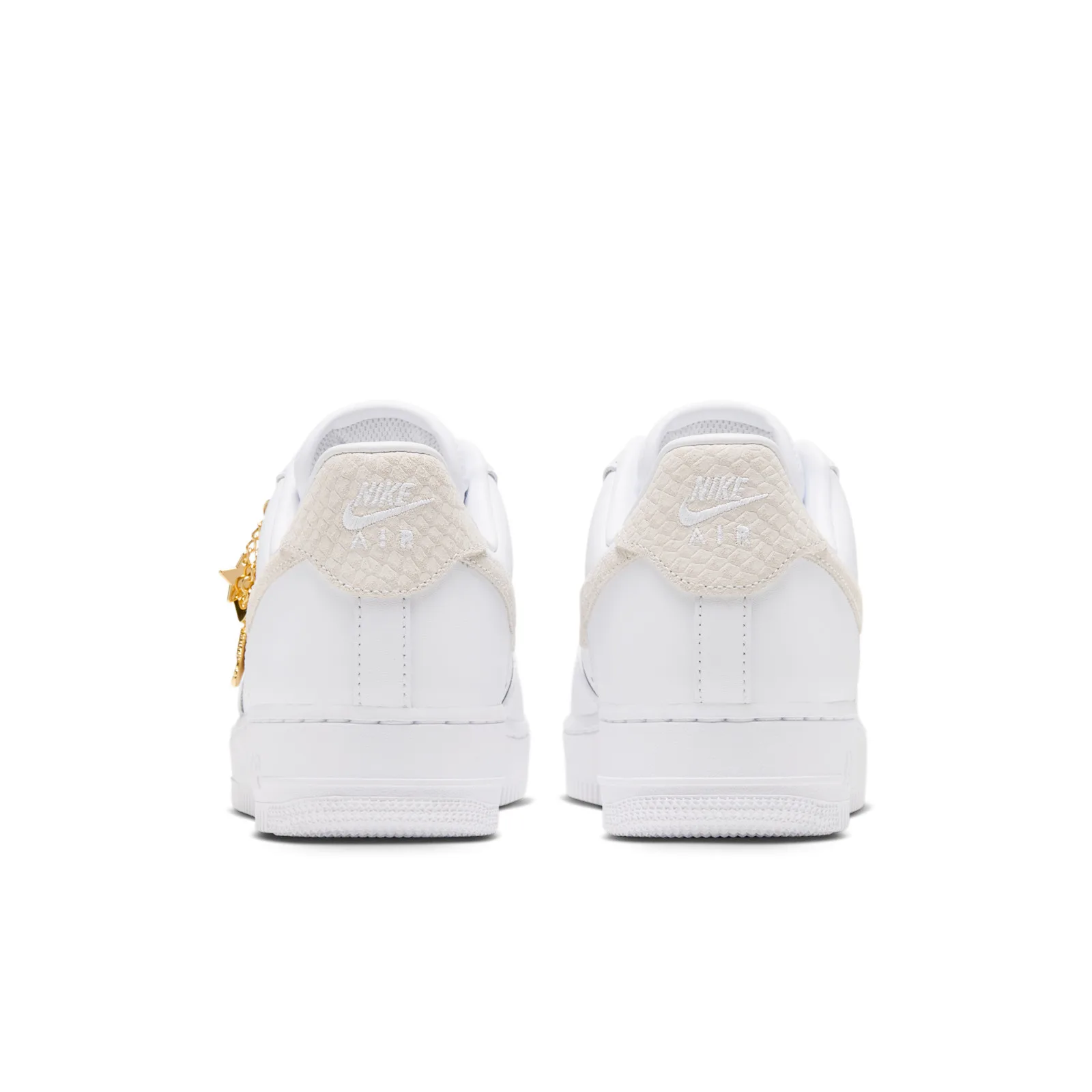 heel view of pair, cream suede Nike Air tabs, gold charms dangling off left shoe, Metallic Gold Charms