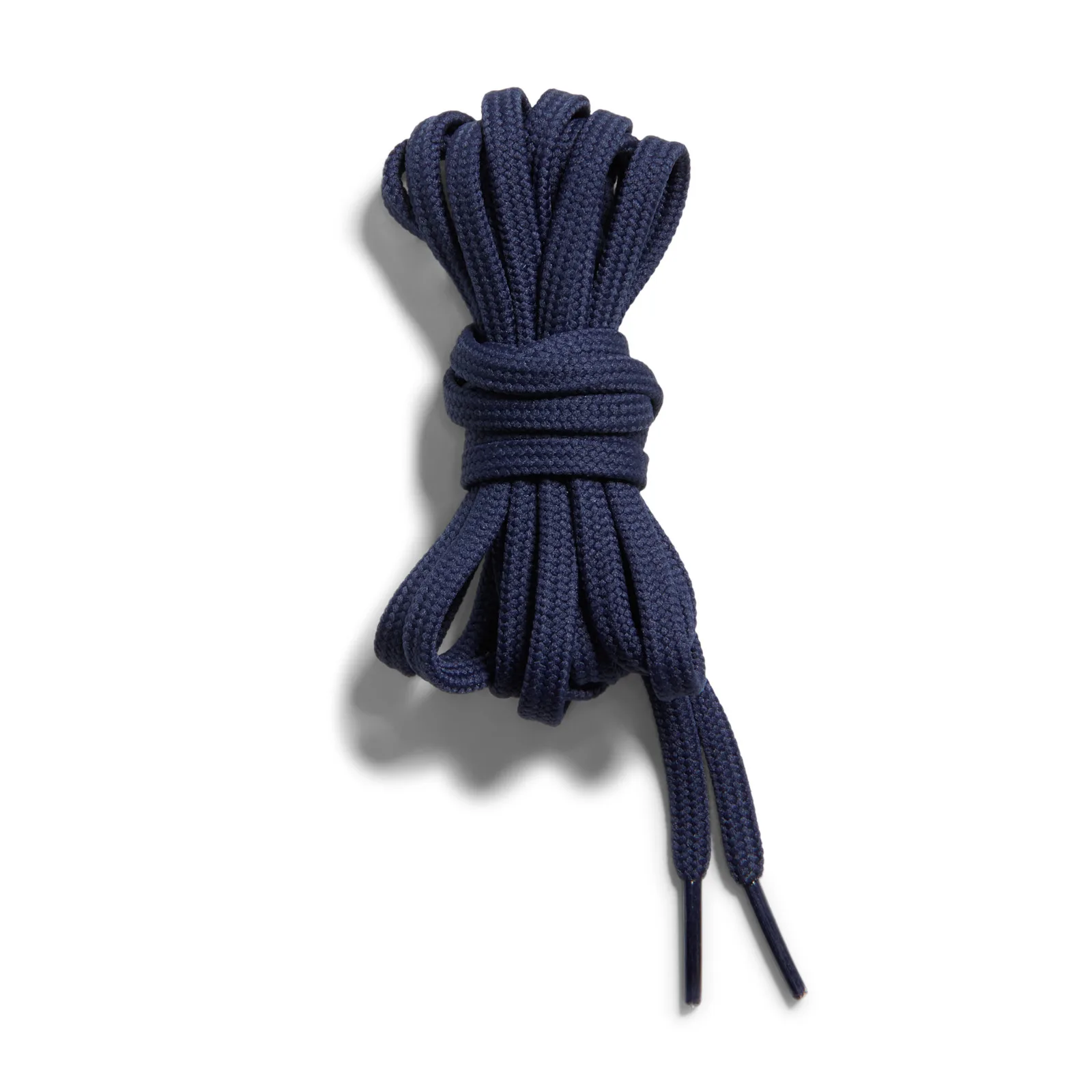 detail shot of coiled navy laces on a white background, Low Mini Swoosh