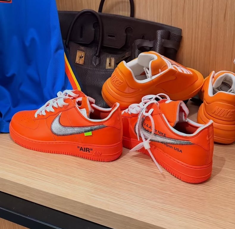 pairs on wood shelf with silver swoosh, white laces, near a black bag, Nike Air Force 1 Low Virgil Abloh Archive (Orange)