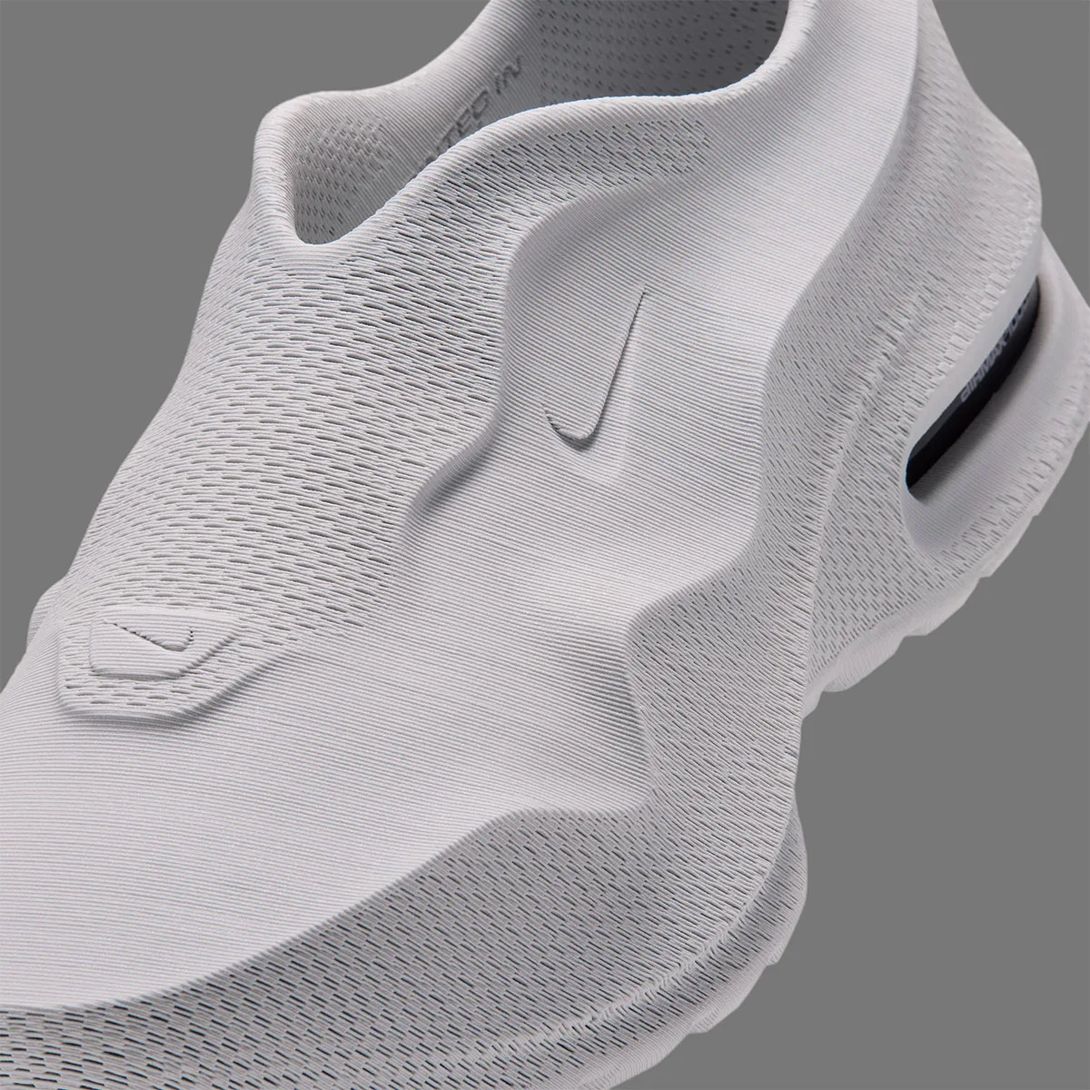 close-up detail of the tongue and heel, tonal Swoosh and dark heel window with white text, Air Max 1000.3